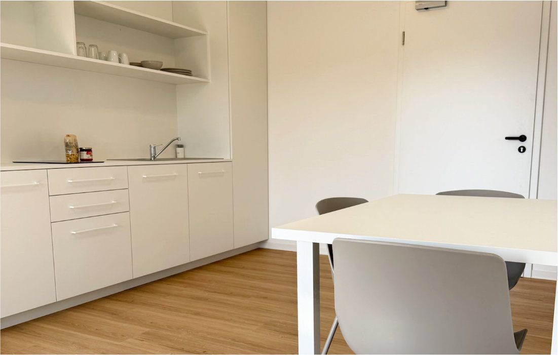 Compact kitchenette with storage and shelving